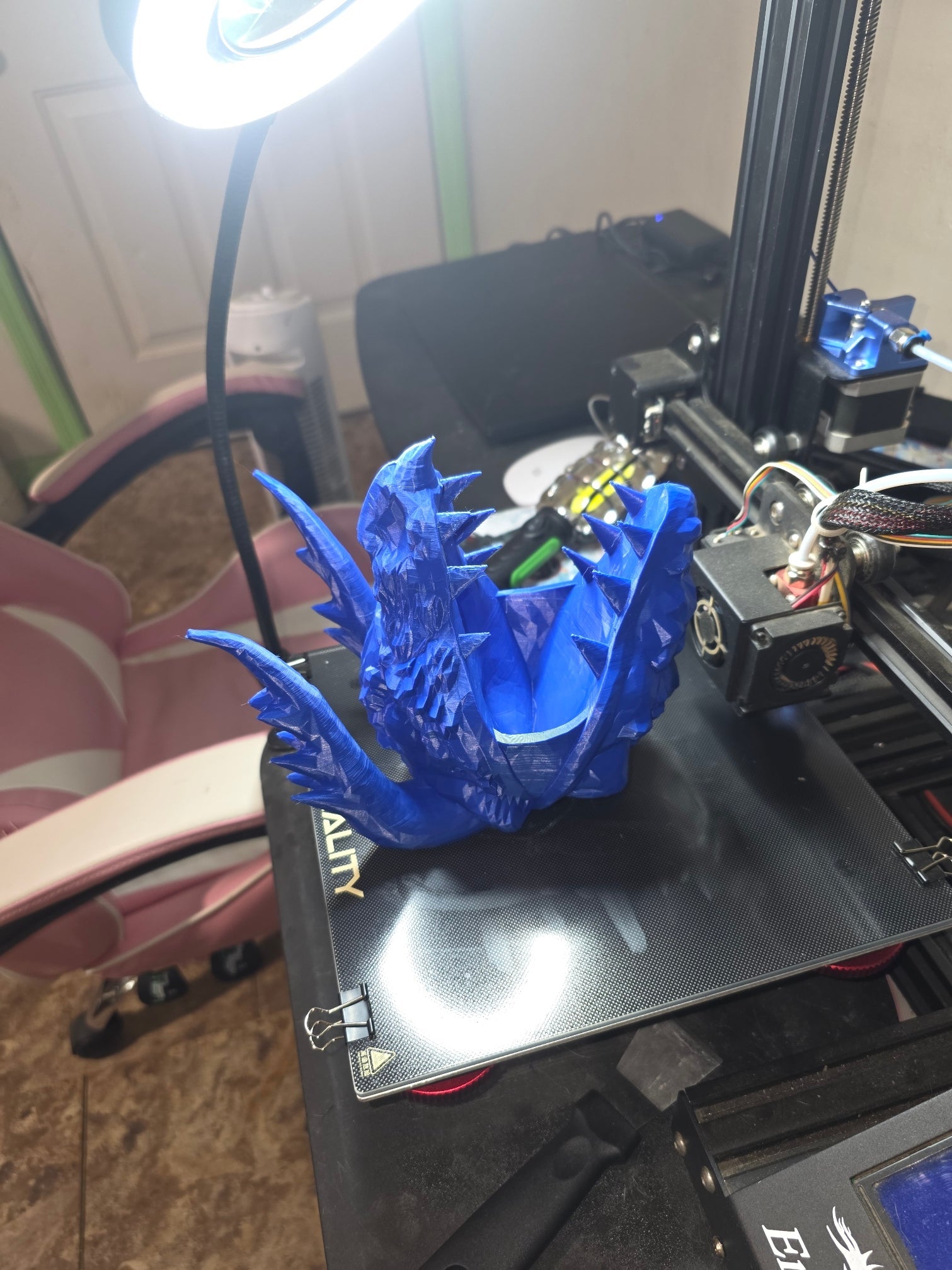 3D printed blue dragon skull pen holder — side angle showing horn and scale detail